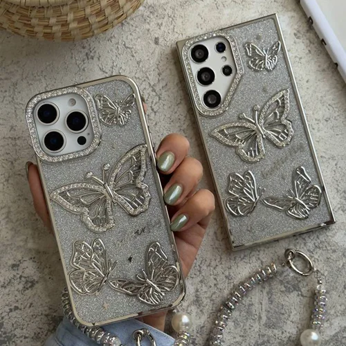 قاب موبایل ( آیفون – سامسونگ ) پروانه آموره نگین دار برجسته شاینی + بندستC006387